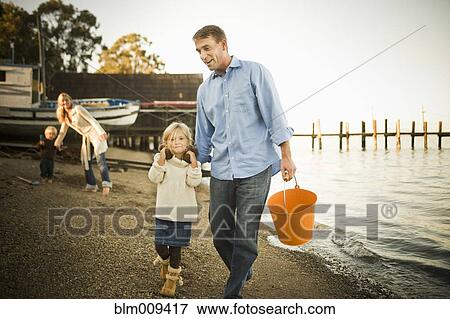 Caucasian family enjoying the beach View Large Photo Image Stock Photo - Caucasian family enjoying the beach. Fotosearch
