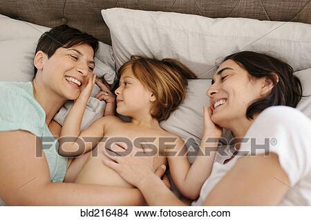 Caucasian family playing in bed View Large Photo Image Picture - Caucasian family playing in bed. Fotosearch