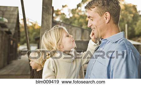 Stock Photo - Caucasian father and children outdoors. Fotosearch
