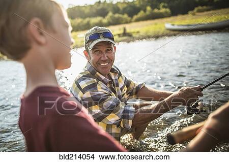 Caucasian father and son fishing in river View Large Photo Image Picture - Caucasian father and son fishing in river. Fotosearch