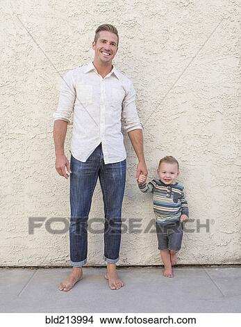 Caucasian father and son holding hands outdoors View Large Photo Image Picture - Caucasian father and son holding hands outdoors. Fotosearch