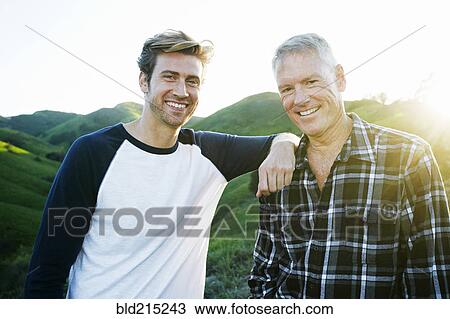 Caucasian father and son smiling on rural hilltop View Large Photo Image Stock Image - Caucasian father and son smiling on rural hilltop. Fotosearch