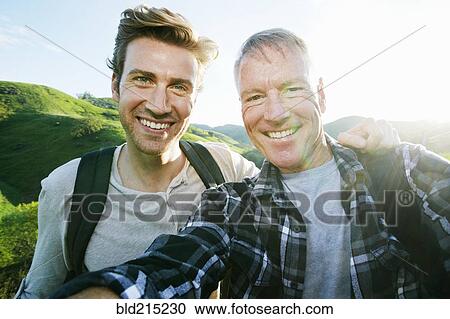 Caucasian father and son taking selfie on rural hilltop View Large Photo Image Stock Image - Caucasian father and son taking selfie on rural hilltop. Fotosearch
