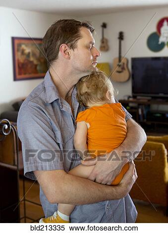 Caucasian father cradling toddler daughter View Large Photo Image Stock Photography - Caucasian father cradling toddler daughter. Fotosearch