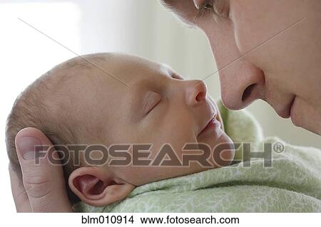 Picture - Caucasian father holding newborn baby boy. Fotosearch