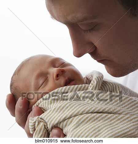 Stock Photography - Caucasian father holding newborn baby boy. Fotosearch
