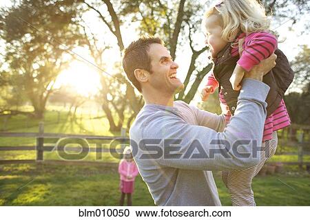 Caucasian father lifting daughter View Large Photo Image Stock Image - Caucasian father lifting daughter. Fotosearch