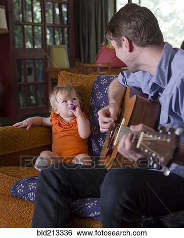 Caucasian father playing guitar for daughter View Large Photo Image Stock Photograph - Caucasian father playing guitar for daughter. Fotosearch