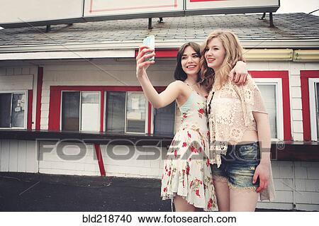 Caucasian friends taking selfie with cell phone View Large Photo Image Stock Image - Caucasian friends taking selfie with cell phone. Fotosearch