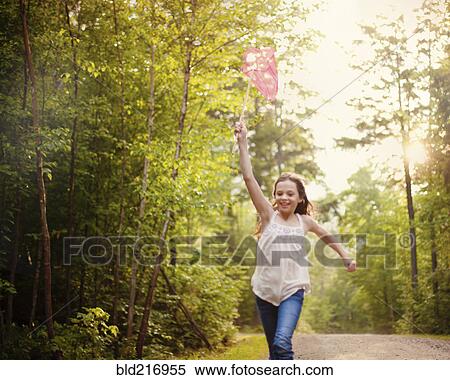 Stock Photography - Caucasian girl carrying butterfly net. Fotosearch