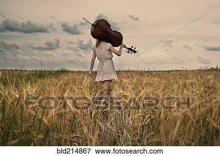 Caucasian girl carrying cello on shoulder in rural fieldCaption View Large Photo Image Stock Photo - Caucasian girl carrying cello on shoulder in rural fieldCaption. Fotosearch