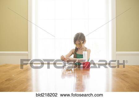 Caucasian girl cooking at table View Large Photo Image Stock Image - Caucasian girl cooking at table. Fotosearch
