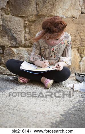Caucasian girl drawing on concrete ground View Large Photo Image Stock Photo - Caucasian girl drawing on concrete ground. Fotosearch