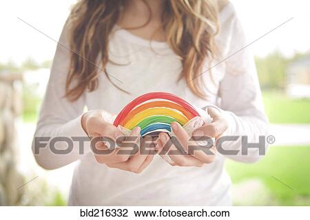 Caucasian girl holding rainbow candy View Large Photo Image Stock Image - Caucasian girl holding rainbow candy. Fotosearch