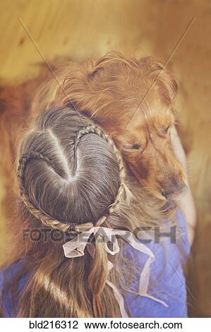 Stock Image - Caucasian girl hugging dog. Fotosearch