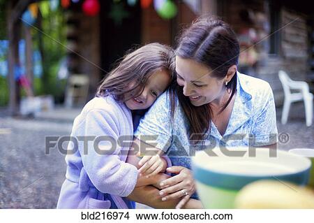 Caucasian girl hugging mother outdoors View Large Photo Image Picture - Caucasian girl hugging mother outdoors. Fotosearch