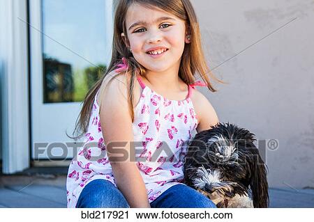 Caucasian girl hugging puppy on patio View Large Photo Image Stock Image - Caucasian girl hugging puppy on patio. Fotosearch