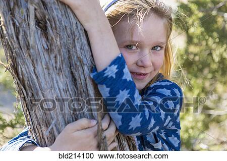 Caucasian girl hugging tree outdoors View Large Photo Image Stock Image - Caucasian girl hugging tree outdoors. Fotosearch