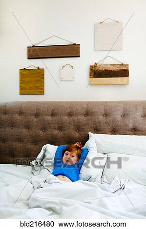 Caucasian girl laying in bed View Large Photo Image Stock Image - Caucasian girl laying in bed. Fotosearch