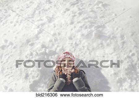 Caucasian girl laying in snow View Large Photo Image Stock Photograph - Caucasian girl laying in snow. Fotosearch