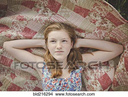 Caucasian girl laying on blanket View Large Photo Image Picture - Caucasian girl laying on blanket. Fotosearch