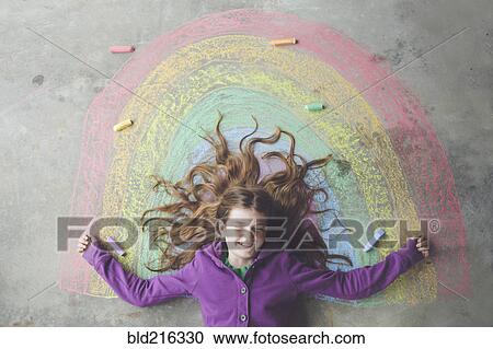 Caucasian girl laying on chalk rainbow View Large Photo Image Stock Image - Caucasian girl laying on chalk rainbow. Fotosearch