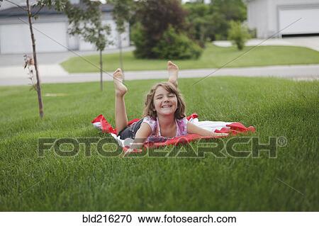 Caucasian girl laying on lawn in suburban neighborhood View Large Photo Image Stock Image - Caucasian girl laying on lawn in suburban neighborhood. Fotosearch