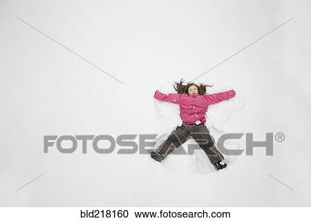 Caucasian girl making snow angel View Large Photo Image Stock Image - Caucasian girl making snow angel. Fotosearch