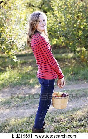 Caucasian girl picking fruit in orchard View Large Photo Image Stock Image - Caucasian girl picking fruit in orchard. Fotosearch