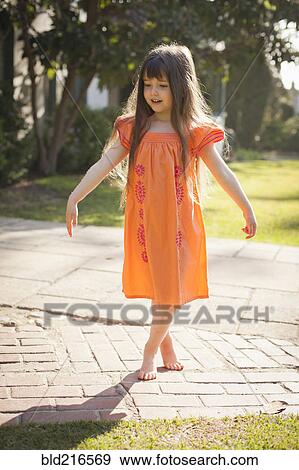 Caucasian girl playing barefoot in backyard View Large Photo Image Stock Photo - Caucasian girl playing barefoot in backyard. Fotosearch