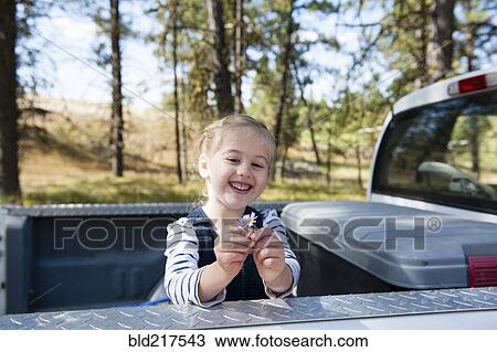 Caucasian girl playing in truck bed View Large Photo Image Stock Image - Caucasian girl playing in truck bed. Fotosearch