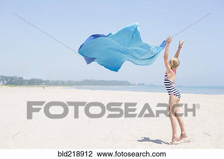 Caucasian girl playing with fabric on beach View Large Photo Image Stock Image - Caucasian girl playing with fabric on beach. Fotosearch