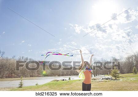 Caucasian girl playing with ribbons in park View Large Photo Image Stock Photography - Caucasian girl playing with ribbons in park. Fotosearch