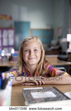 Caucasian girl sitting at desk in classroom View Large Photo Image Stock Photograph - Caucasian girl sitting at desk in classroom. Fotosearch