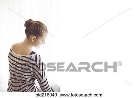 Caucasian girl sitting at sheer curtains View Large Photo Image Stock Photo - Caucasian girl sitting at sheer curtains. Fotosearch