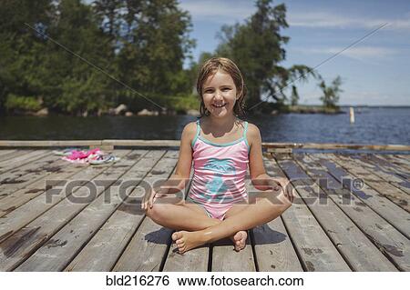 Caucasian girl sitting on wooden dock over lake View Large Photo Image Stock Photograph - Caucasian girl sitting on wooden dock over lake. Fotosearch