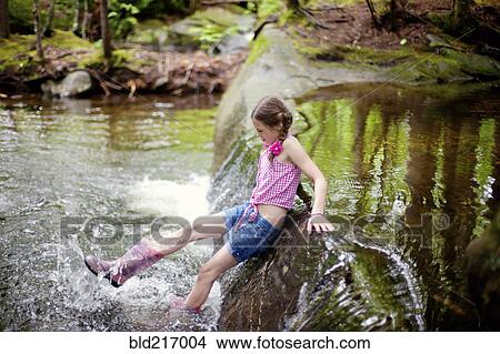 Picture - Caucasian girl splashing in river. Fotosearch