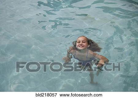 Caucasian girl swimming in pool View Large Photo Image Stock Photo - Caucasian girl swimming in pool. Fotosearch