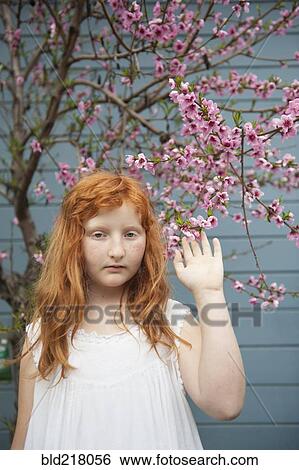 Caucasian girl waving under flowering tree View Large Photo Image Stock Photograph - Caucasian girl waving under flowering tree. Fotosearch