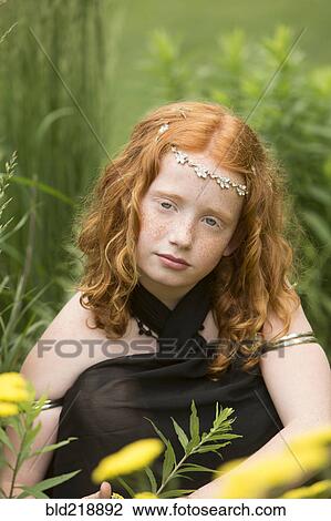 Caucasian girl wearing flower crown in garden View Large Photo Image Stock Image - Caucasian girl wearing flower crown in garden. Fotosearch