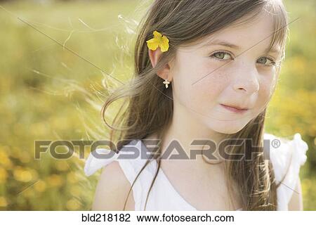 Caucasian girl wearing flower in her hair View Large Photo Image Stock Image - Caucasian girl wearing flower in her hair. Fotosearch