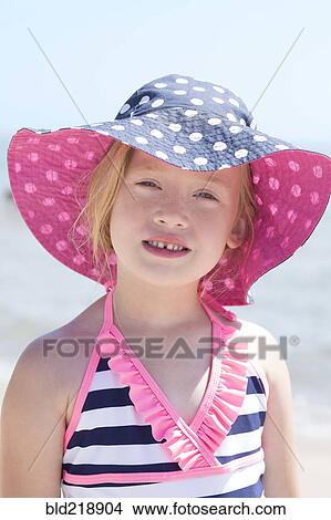 Caucasian girl wearing sun hat and bathing suit on beach View Large Photo Image Picture - Caucasian girl wearing sun hat and bathing suit on beach. Fotosearch