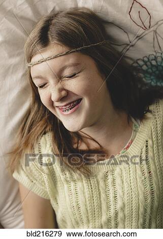 Caucasian girl with braces wearing braid headband View Large Photo Image Stock Photo - Caucasian girl with braces wearing braid headband. Fotosearch