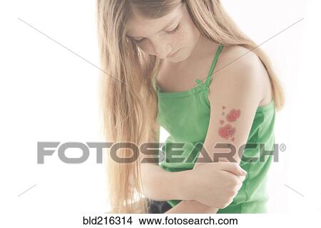 Picture - Caucasian girl with temporary tattoo on arm. Fotosearch