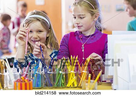 Caucasian girls choosing multicolor pencils in classroom View Large Photo Image Stock Photo - Caucasian girls choosing multicolor pencils in classroom. Fotosearch