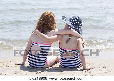 Caucasian girls hugging on beach View Large Photo Image Stock Photograph - Caucasian girls hugging on beach. Fotosearch