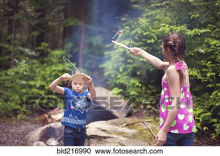 Caucasian girls playing with toys in forest Stock Image ...