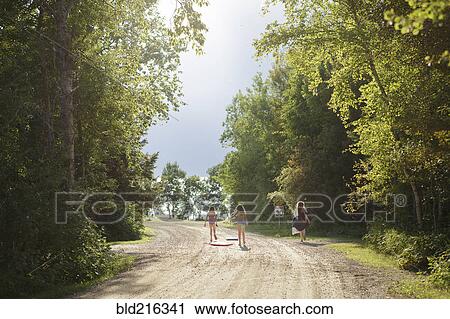 Caucasian girls walking on dirt road View Large Photo Image Stock Image - Caucasian girls walking on dirt road. Fotosearch
