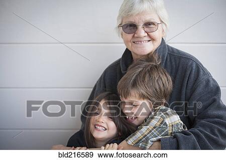 Caucasian grandmother and grandchildren smiling outdoors View Large Photo Image Stock Photo - Caucasian grandmother and grandchildren smiling outdoors. Fotosearch