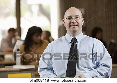 Stock Photo - Caucasian librarian in library. Fotosearch
